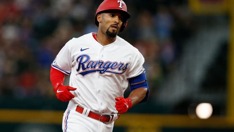 Marcus Semien of the Texas Rangers throws to first base in the first  News Photo - Getty Images