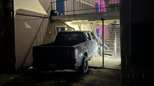 Driver hurt after crashing into Everman apartments