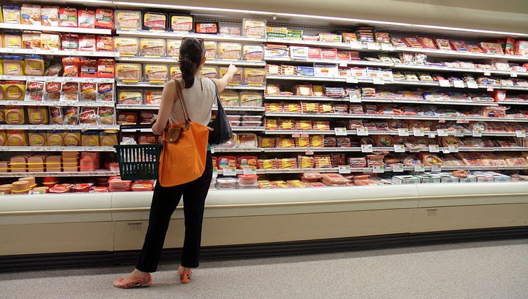 FILE IMAGE - A woman looking at packets of sausages in a grocery store. (Photo by: Jeffrey Greenberg/Universal Images Group via Getty Images)