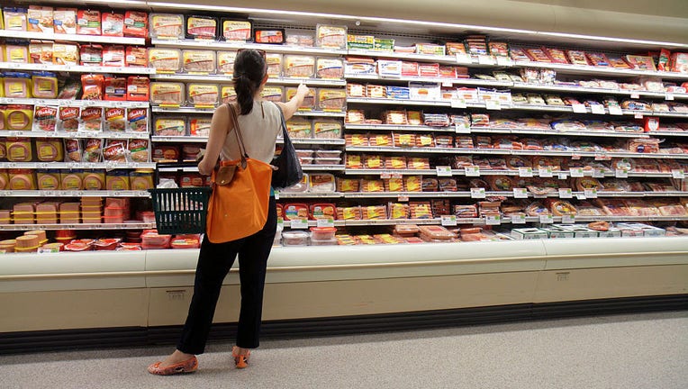 FILE IMAGE - A woman looking at packets of sausages in a grocery store. (Photo by: Jeffrey Greenberg/Universal Images Group via Getty Images)