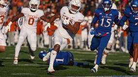 Robinson runs for 243 yards, 4 TDs as Texas routs KU 55-14