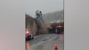 Dramatic video captures truck toppling over California freeway overpass