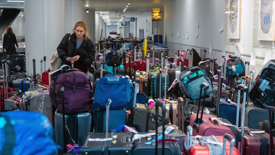 A traveler, after Southwest Airlines flight from Dallas cancellation, drove 22 hours non-stop to Los Angeles and looks for her luggage at baggage claim in LAX Southwest Terminal 1 on Tuesday, Dec. 27, 2022 in Los Angeles, CA. (Irfan Khan / Los Angeles Times via Getty Images)