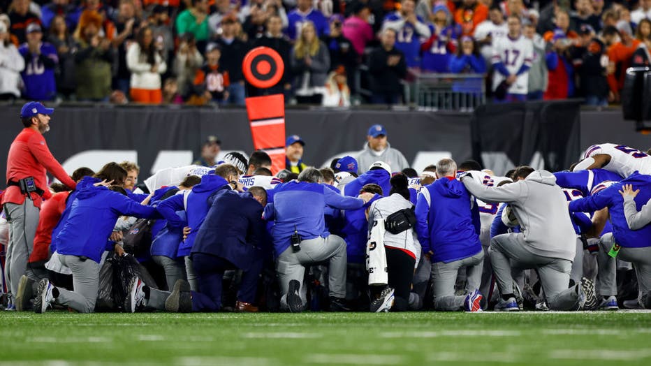 Buffalo Bills players and staff kneel together in solidarity after Damar Hamlin #3 sustained an injury during the first quarter of an NFL football game against the Cincinnati Bengals at Paycor Stadium on Jan. 2, 2023, in Cincinnati, Ohio. (Photo by Kevin Sabitus/Getty Images)