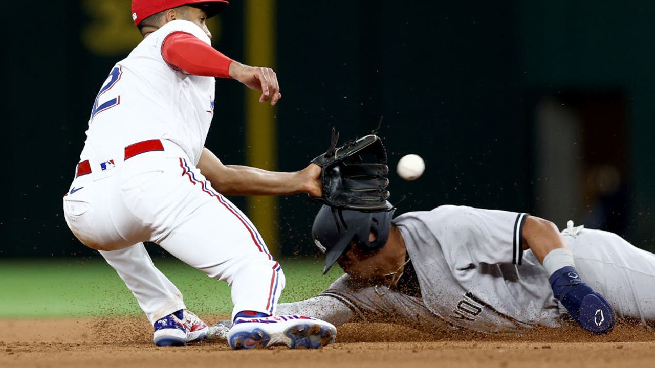 Texas Rangers' Ezequiel Duran, left, is caught stealing second