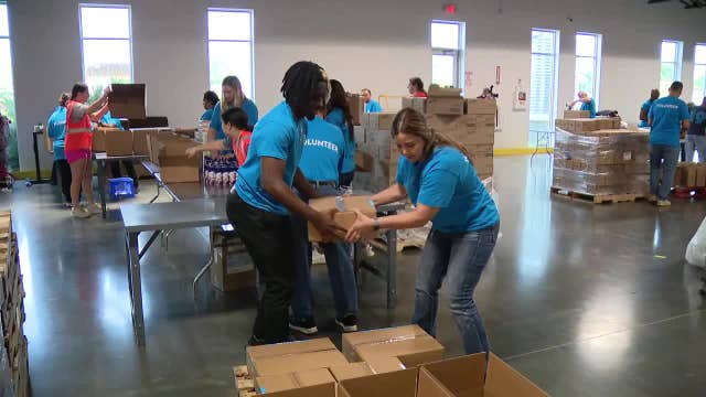 North Texas Food Bank volunteers putting together disaster relief kits