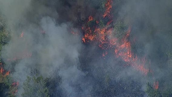 Wildfire destroys outbuilding, threatens homes in Hill County