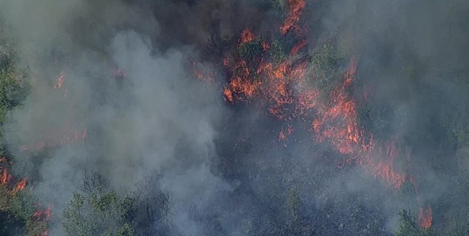 Wildfire destroys outbuilding, threatens homes in Hill County