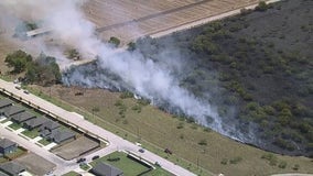 Crews battle brush fire near homes in Krum