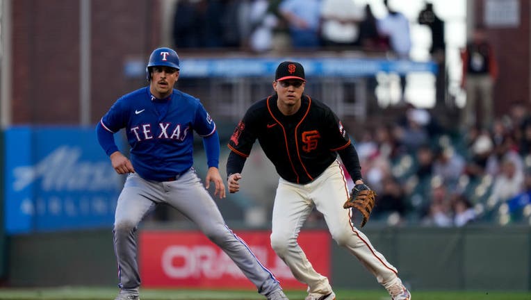 Leody Taveras of the Texas Rangers and manager Bruce Bochy