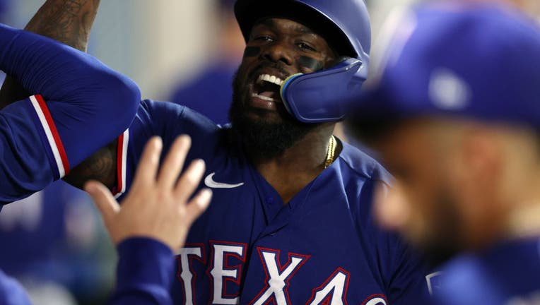 Adolis Garcia of the Texas Rangers celebrates after hitting a solo News  Photo - Getty Images