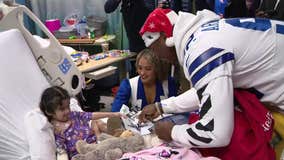 Dallas Cowboys players and cheerleaders bring gifts to kids in local hospitals