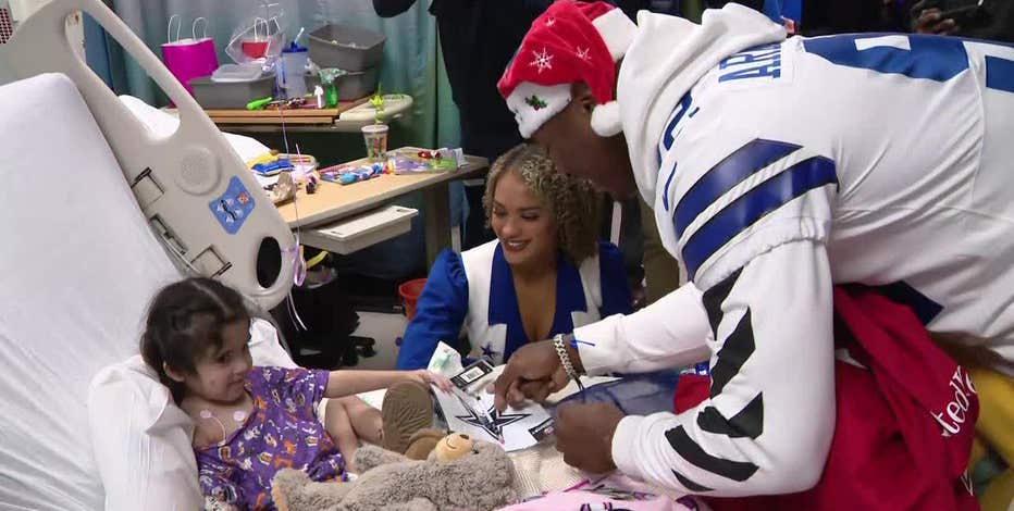 Dallas Cowboys players and cheerleaders bring gifts to kids in local hospitals
