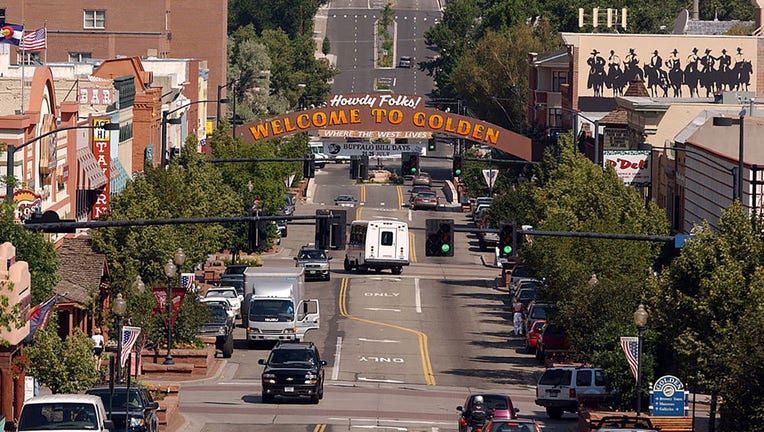 FILE - Cars drive in historic downtown Golden, Colorado, home of the Adolph Coors Co., on July 22, 2004. (Photo by Matt Staver/Bloomberg via Getty Images)