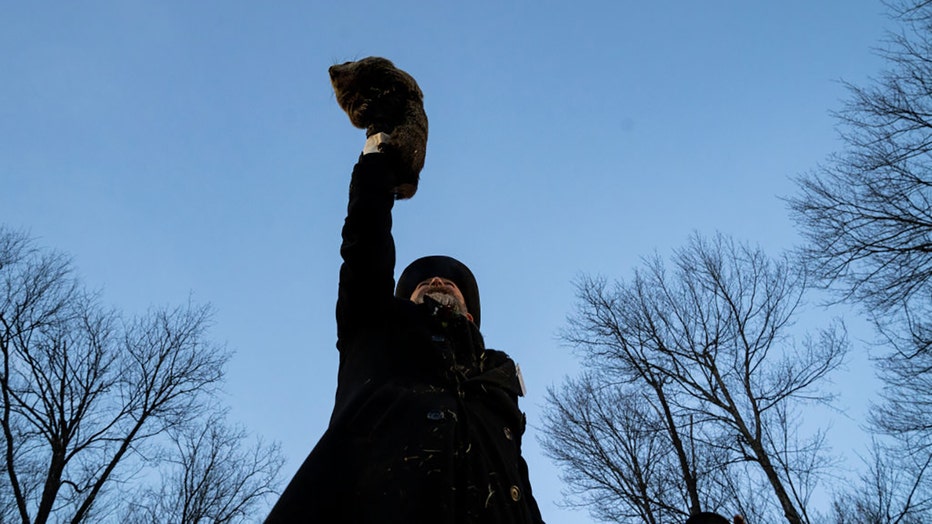 Groundhog handler AJ Derume and Punxsutawney Phil, who saw his shadow, predicting a late spring during the 137th annual Groundhog Day festivities on February 2, 2023 in Punxsutawney, Pennsylvania. Groundhog Day is a popular tradition in the United States and Canada. A crowd of upwards of 5,000 people spent a night of revelry awaiting the sunrise and the groundhogs exit from his winter den. If Punxsutawney Phil sees his shadow he regards it as an omen of six more weeks of bad weather and returns to his den. Early spring arrives if he does not see his shadow, causing Phil to remain above ground. (Photo by Michael Swensen/Getty Images)