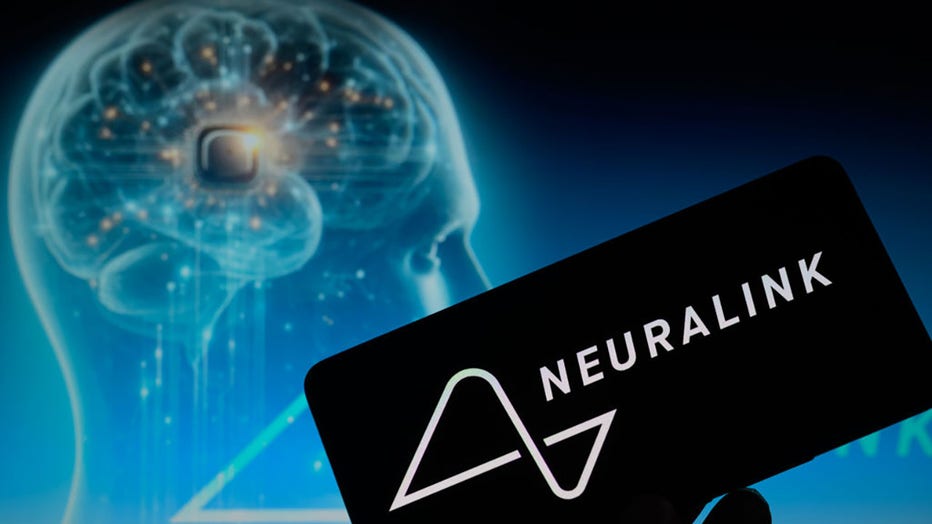 The Neuralink logo is being displayed on a smartphone with a brain chip visible in the background in this photo illustration on Jan. 30, 2024. (Photo by Jonathan Raa/NurPhoto via Getty Images)