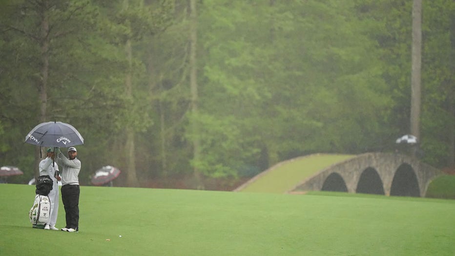 FILE - Jon Rahm stands under an umbrella with his caddie during Round Two of the Masters Tournament at Augusta National. Augusta, GA, on April 8, 2023. (Photo by Erick W. Rasco/Sports Illustrated via Getty Images)