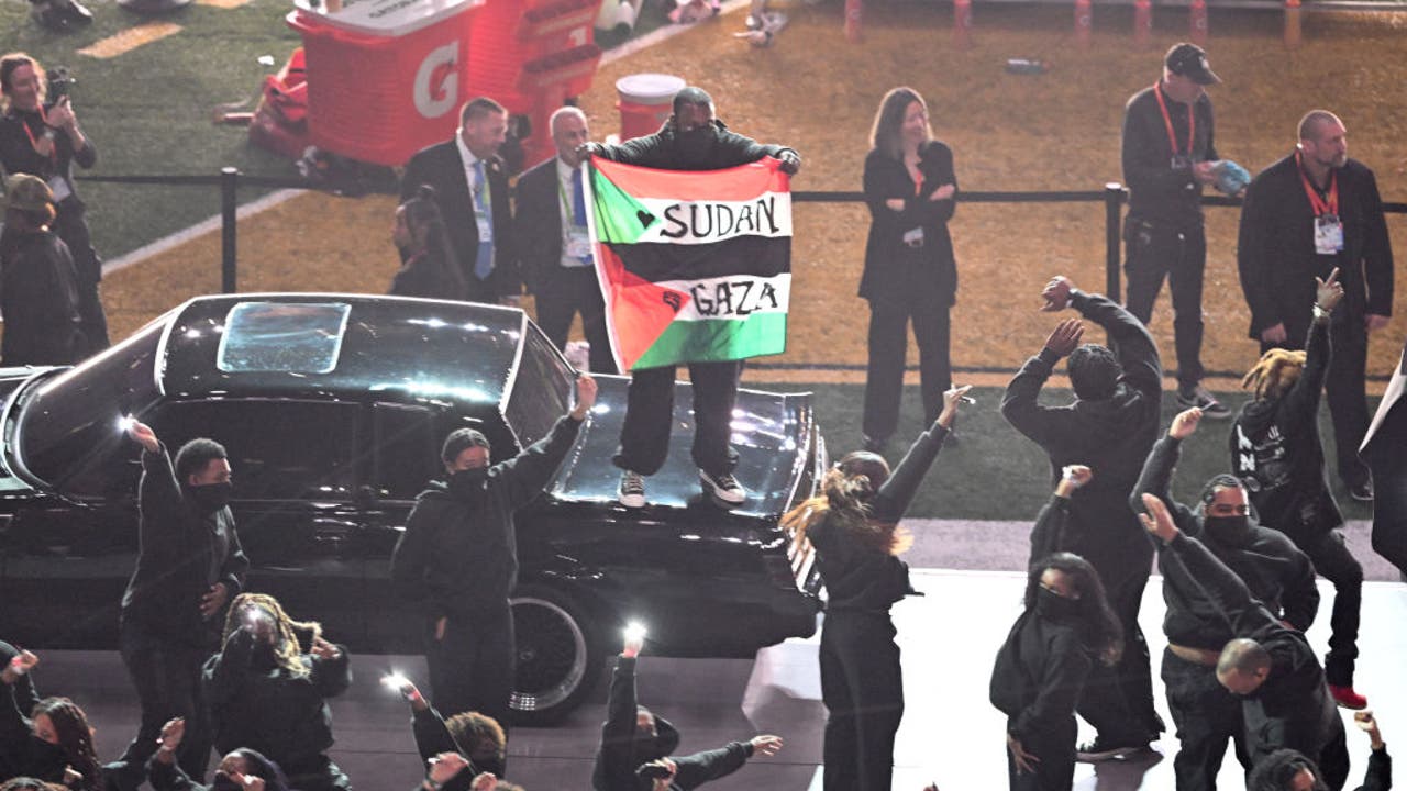 Protester holds Palestinian flag during Kendrick Lamar's Super Bowl halftime show