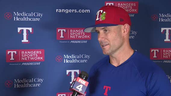 Rangers manager Skip Schumaker chats before first spring training game
