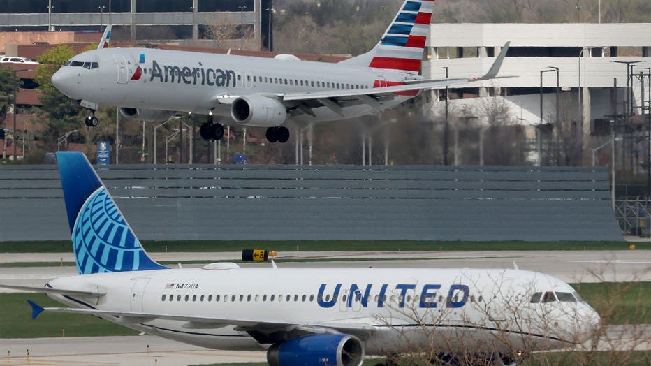 An American Airlines jet approaches the runway as a United Airlines jet taxis at O'Hare International Airport on April 14, 2026, in Chicago.