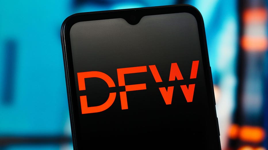 In this photo illustration, the Dallas Fort Worth International Airport (DFW) logo is seen displayed on a smartphone screen.