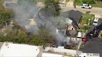 Fort Worth fire damages home and sheds