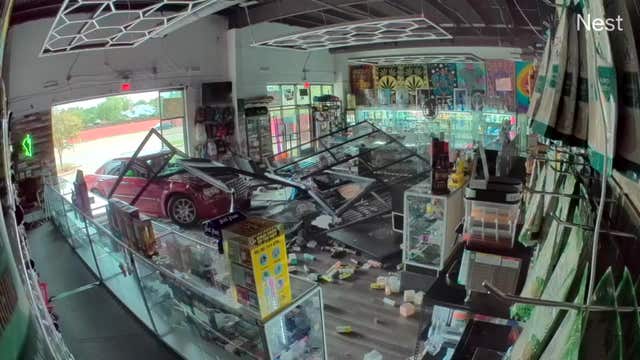 Watch: Car crashes into Carrollton smoke shop, driver was trapped