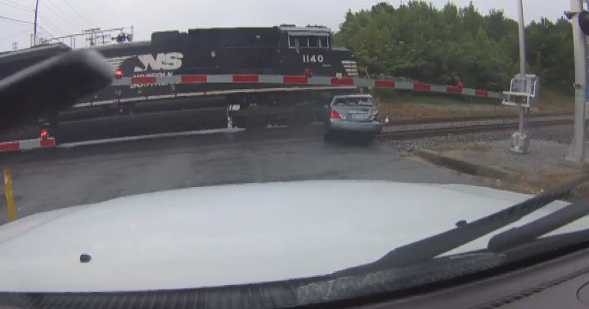 VIDEO: Woman runs out of car just before train hits it | FOX 5 Atlanta
