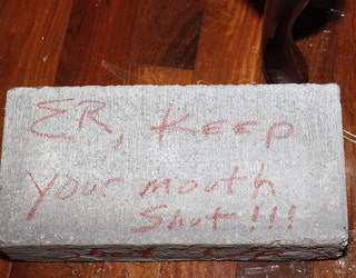 Block thrown through E.R. Mitchell's front window