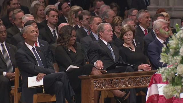 George W. Bush caught passing candy to Michelle Obama at McCain memorial service