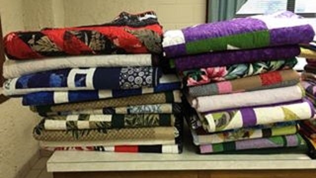 Group donates 24 quilts to home for battered women