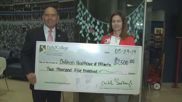 Organization deposits $2,500 into savings accounts for CHOA patients