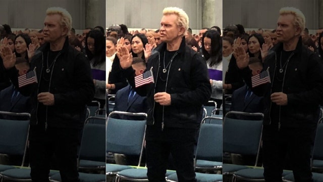 Billy Idol holds American flag as he becomes US citizen