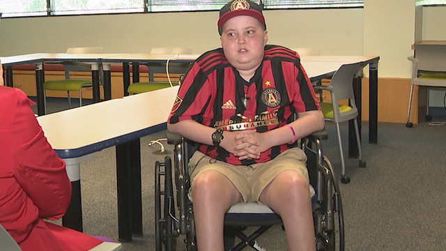 Young soccer player trying to kick cancer