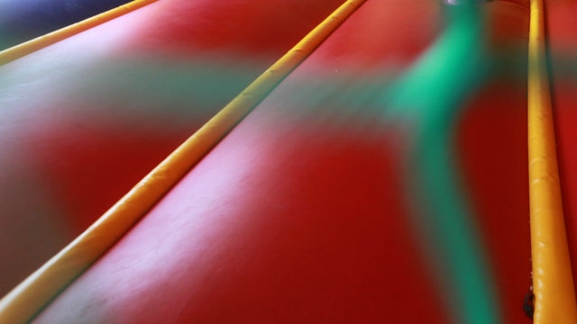 Bounce house with child inside rolls on to highway