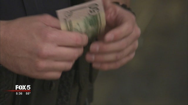 Officers hand out money to Covington residents