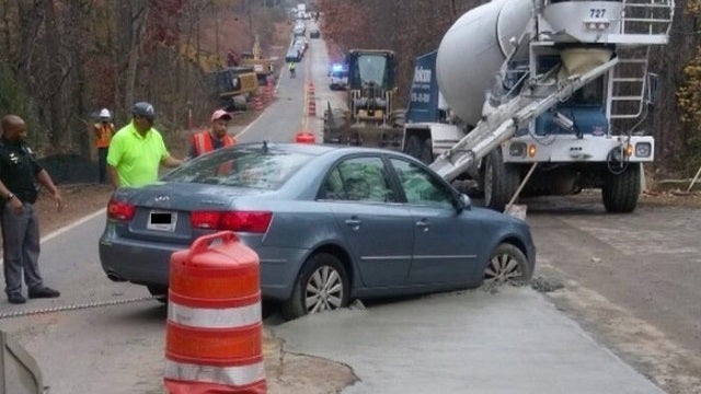 Oops! Tweet shows car stuck in concrete on Johns Creek road