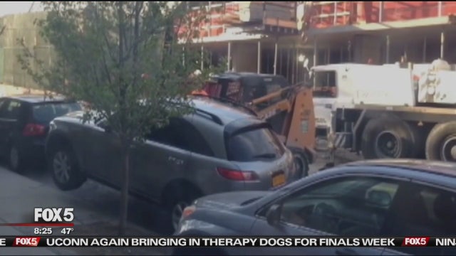 Contractor moves cars out of way with forklift