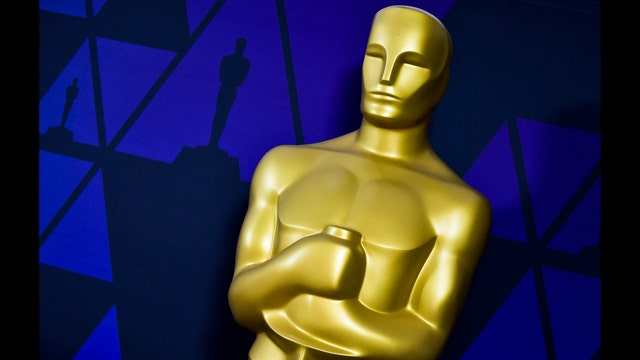 The Latest: Rami Malek falls, but recovers, after Oscar win