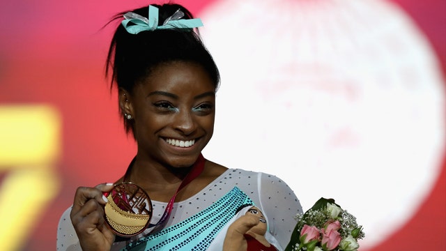 Simone Biles becomes 1st woman to win 4 all-around world titles