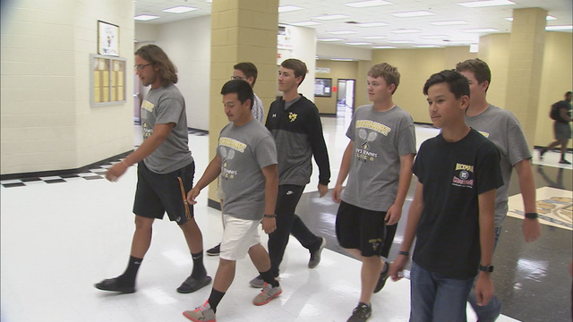 Tennis team steps in and saves a life following a car wreck