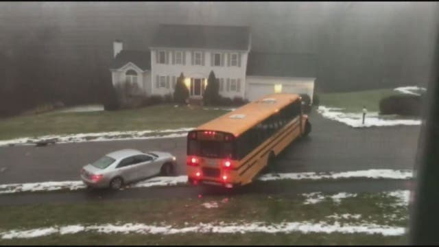 School bus filled with students slides down icy street, crashes into car in Massachusetts