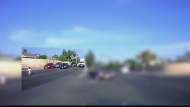 Terrifying video shows child riding through traffic on tricycle
