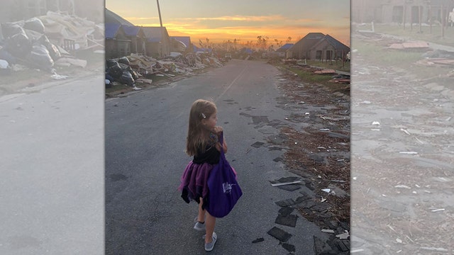Little girl trick-or-treats among hurricane debris in Florida Panhandle