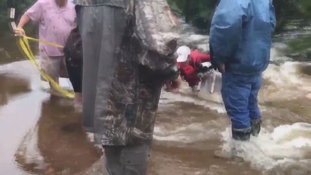 Group helps rescue neighbor's dog from flooding