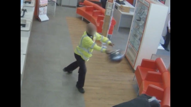 Guard attacks suspect in post office robbery with helmet