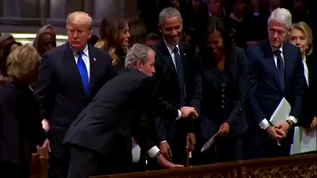 George W. Bush hands Michelle Obama piece of candy at funeral for George H.W. Bush