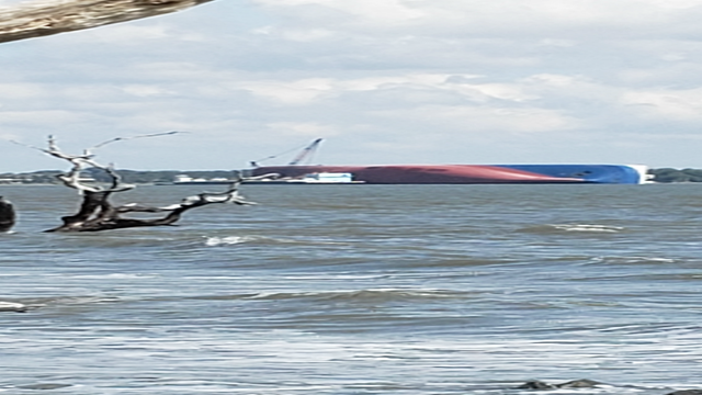 Salvage crews work to remove fuel from capsized ship