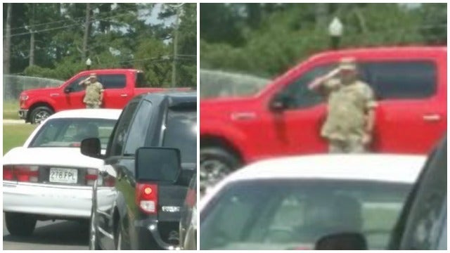 Parent snaps photo of soldier saluting the flag at school