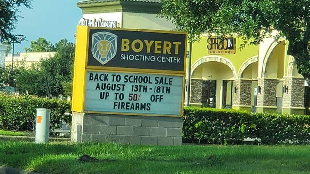 Gun store marquee advertises ‘back to school' sale on firearms